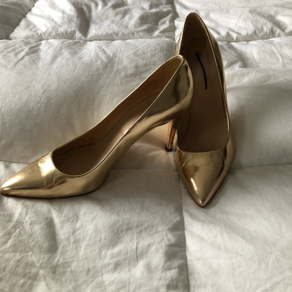 Gold high-heeled shoes